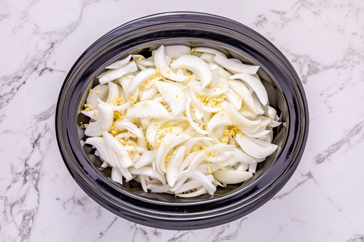 sliced onions and minced garlic added to top of beef