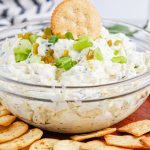 Artichoke Jalapeno Dip in a bowl with crackers