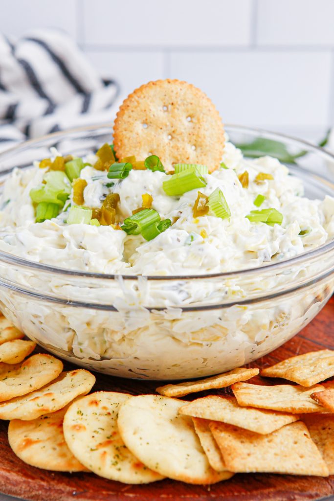 Artichoke Jalapeno Dip in a bowl with crackers