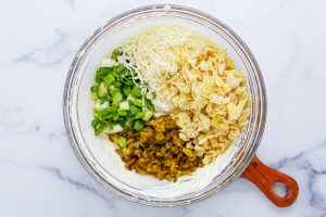 artichoke hearts, cheese, peppers and onions added to bowl