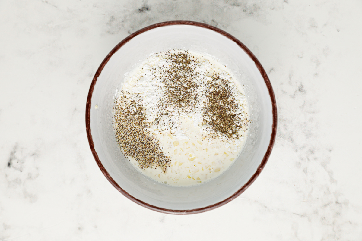 cream, garlic, cornstarch, salt and pepper in a bowl