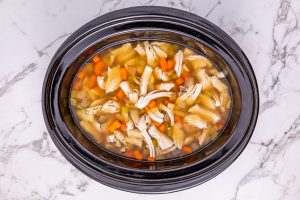 chicken broth or turkey broth, then add Worcestershire sauce, dried herbs, salt, pepper, and bay leaves added to slow cooker