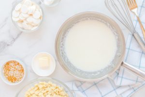heavy whipping cream and champagne in a sauce pan