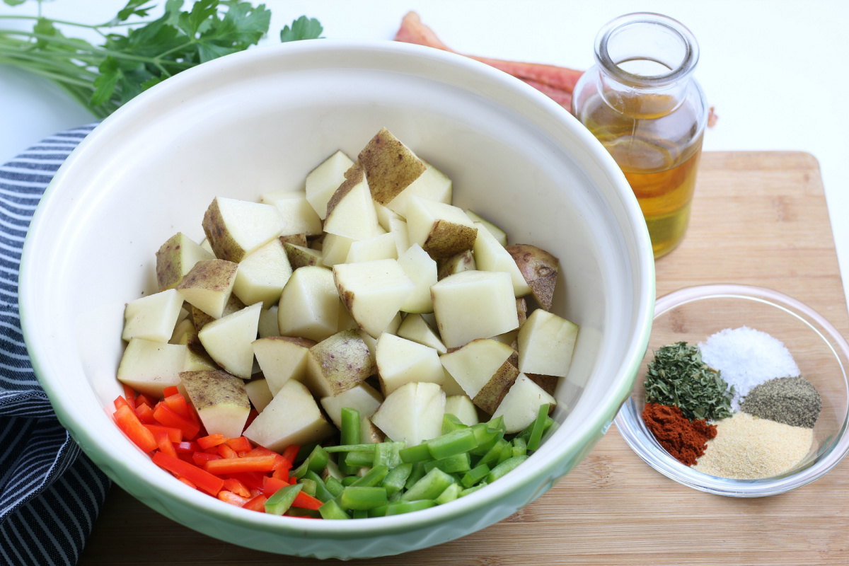 chopped potatoes and peppers in a large mixing bowl
