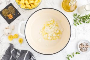 onions in pot with oil