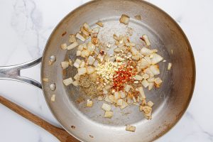 garlic, red pepper flakes and ½ teaspoon of the oregano added to pan with onions