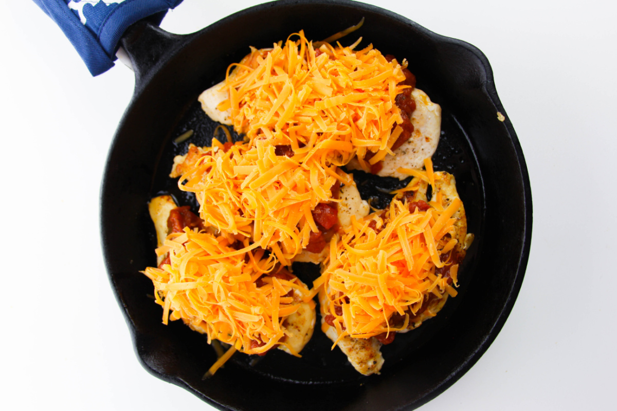 salsa and shredded cheese added to the top of the chicken