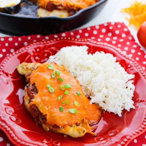 Cheesy Salsa Chicken on a plate with rice
