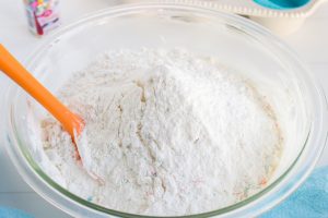 adding cake mix to the bowl