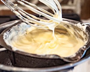 stirring melted chocolate with whisk
