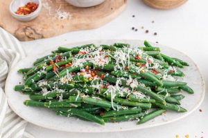 cheese and chili flakes added to top of green beans