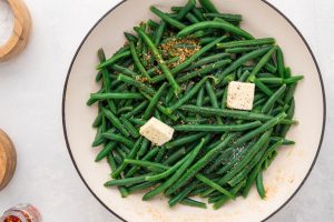 seasoning and butter added to pan with green beans