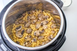 cooked noodles, mushrooms and meatballs in a slow cooker