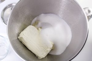 cream cheese and sugar in a mixing bowl