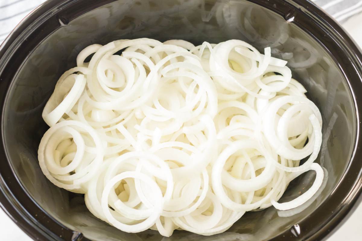 sliced onions in slow cooker