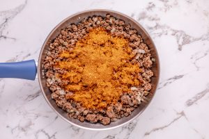 taco seasoning added to pan