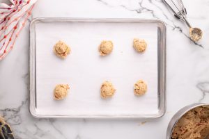 cookie dough balls on baking sheet