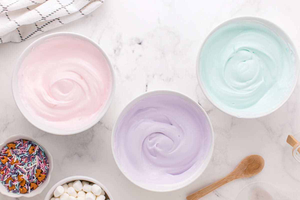 pink, purple and teal colored pudding in 3 different bowls