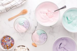 placing 3 different colors of pudding in cups