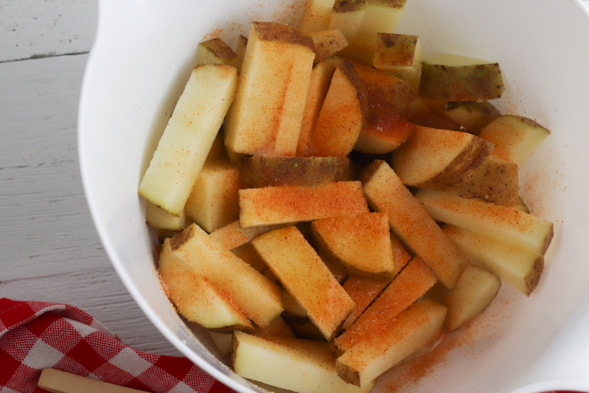 potatoes in a bowl with seasoning