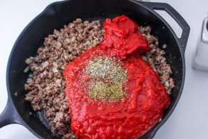 crushed tomatoes, paste and seasoning added to beef