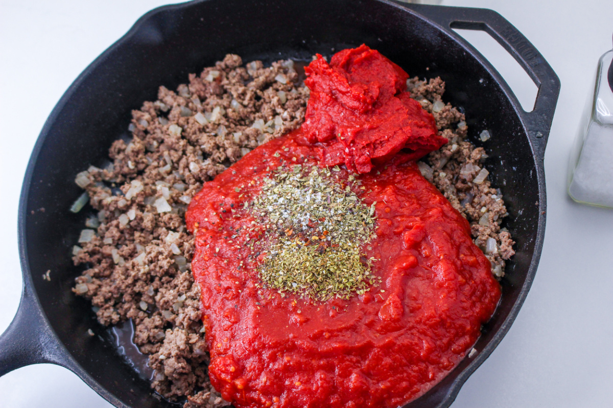 crushed tomatoes, paste and seasoning added to beef