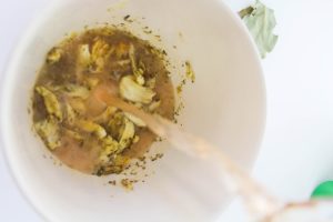 combining the garlic, sour orange juice, lime juice, olive oil, oregano, cumin, salt, and bay leaves in a bowl