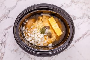 onion, garlic, cream of chicken soup, butter and chicken broth added to slow cooker