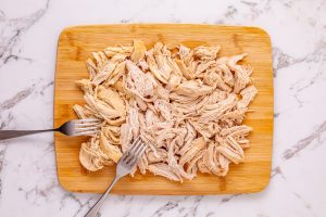 shredded chicken on a cutting board