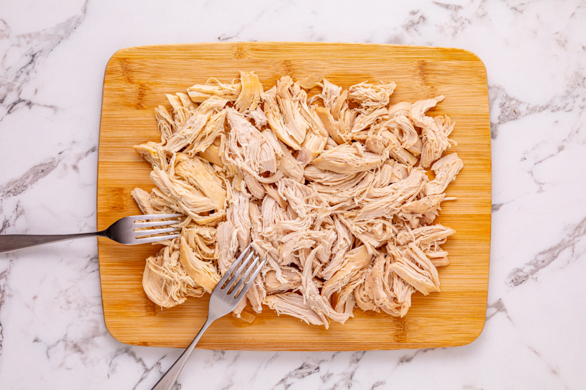 shredded chicken on a cutting board