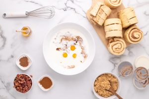eggs, heavy cream, cinnamon, nutmeg, vanilla, salt, and honey to create the egg mixture in a bowl