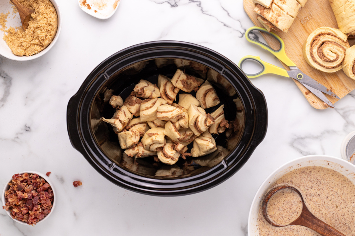 Cinnamon Roll pieces in a slow cooker