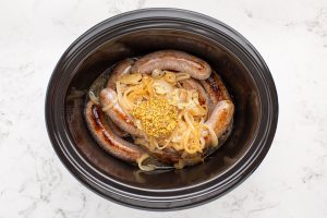 slow cooker beer brats in a crockpot