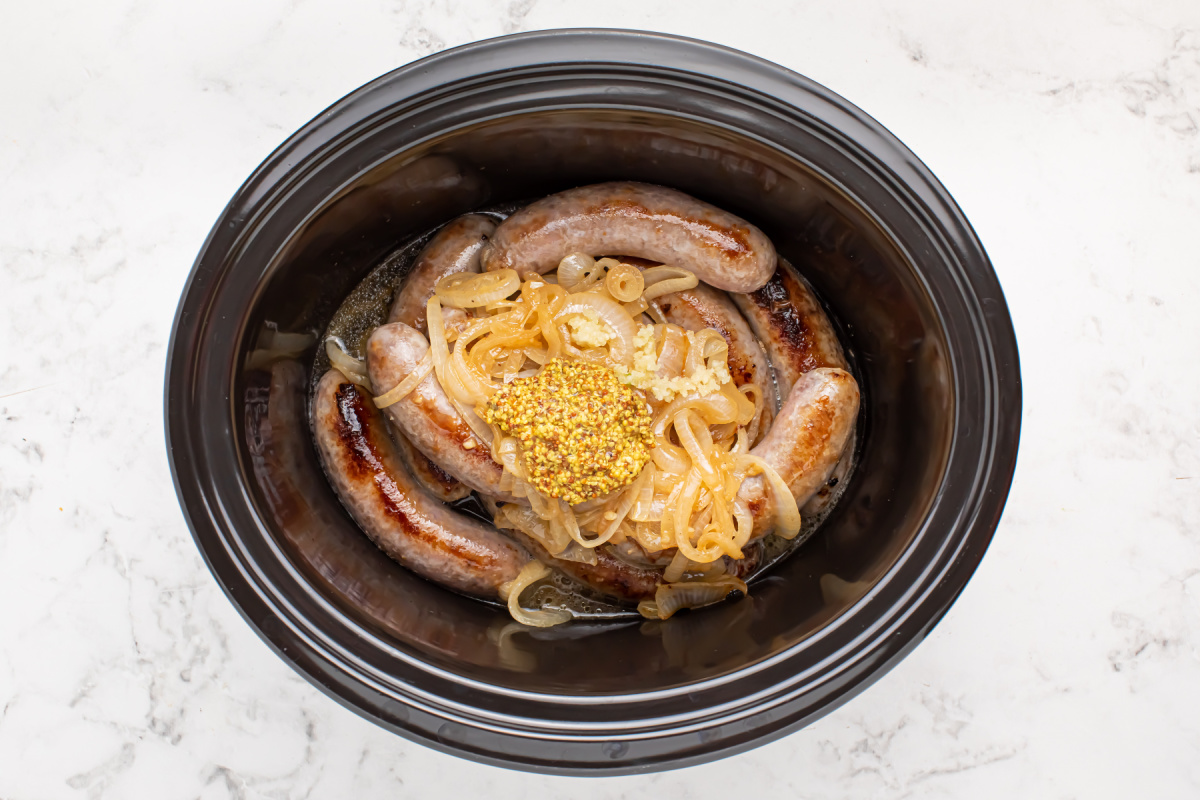 slow cooker beer brats in a crockpot