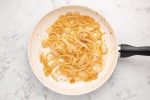 cooking onions in a pan