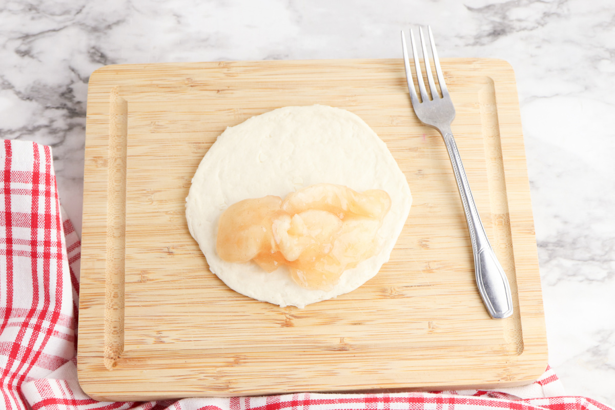 apple pie filling applied to half of the dough