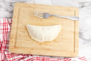 dough folded over and seam pressed with a fork