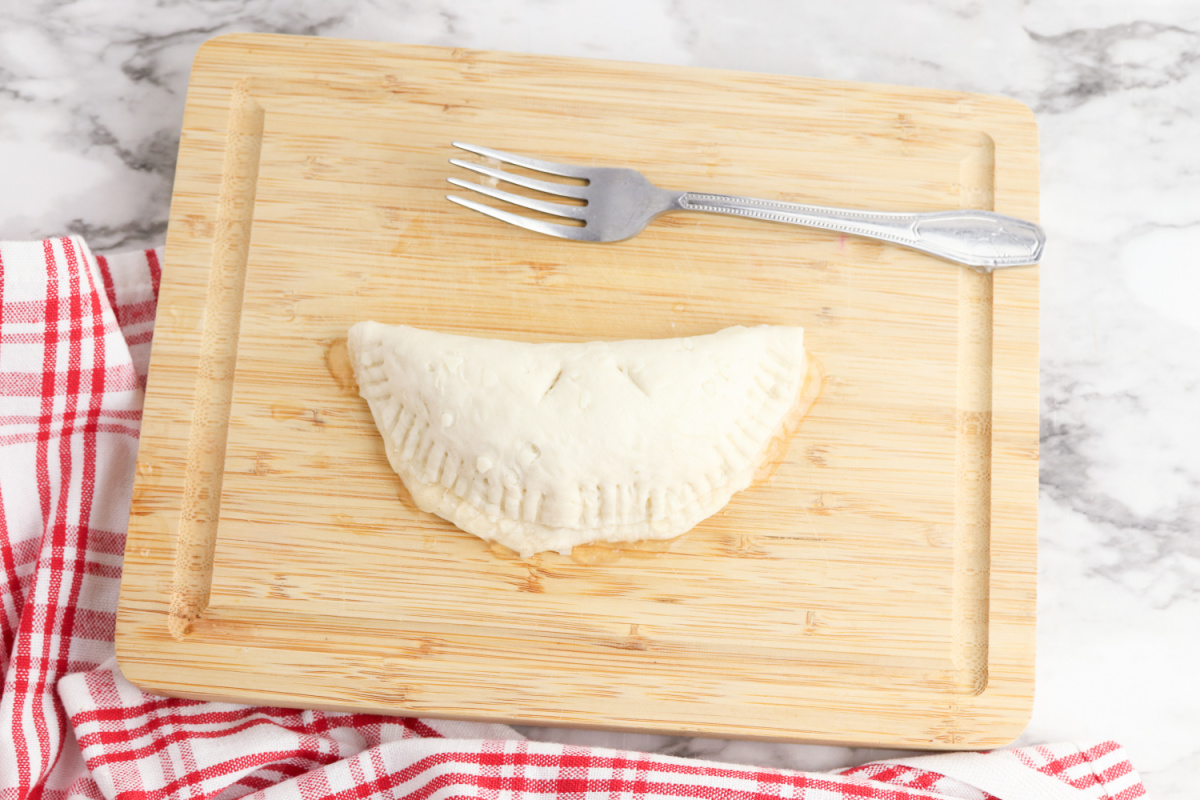 dough folded over and seam pressed with a fork