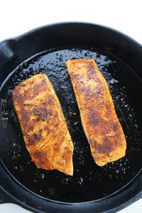 salmon cooking in pan