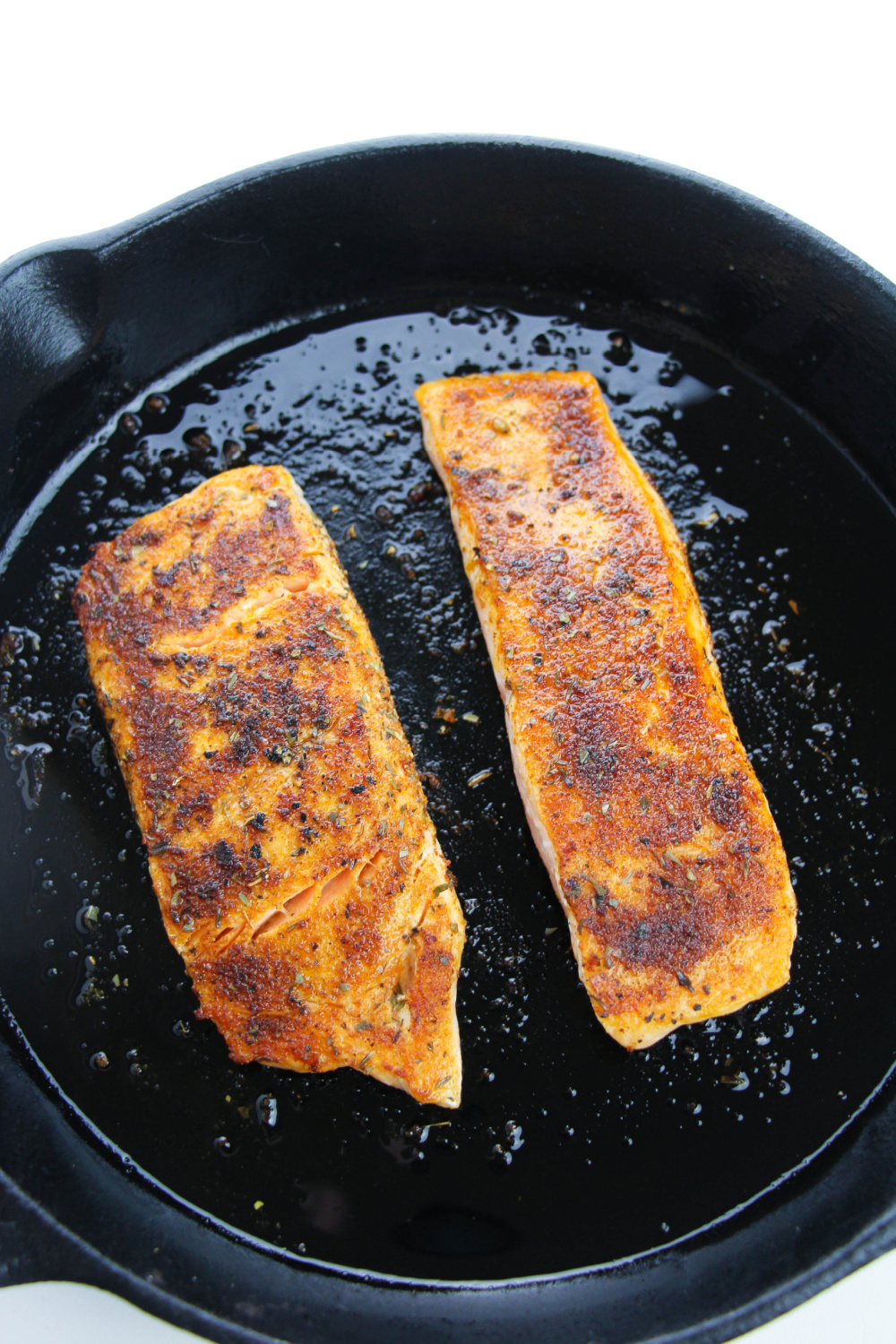 salmon cooking in pan