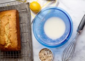 powdered sugar, lemon juice, and almond extract in a bowl