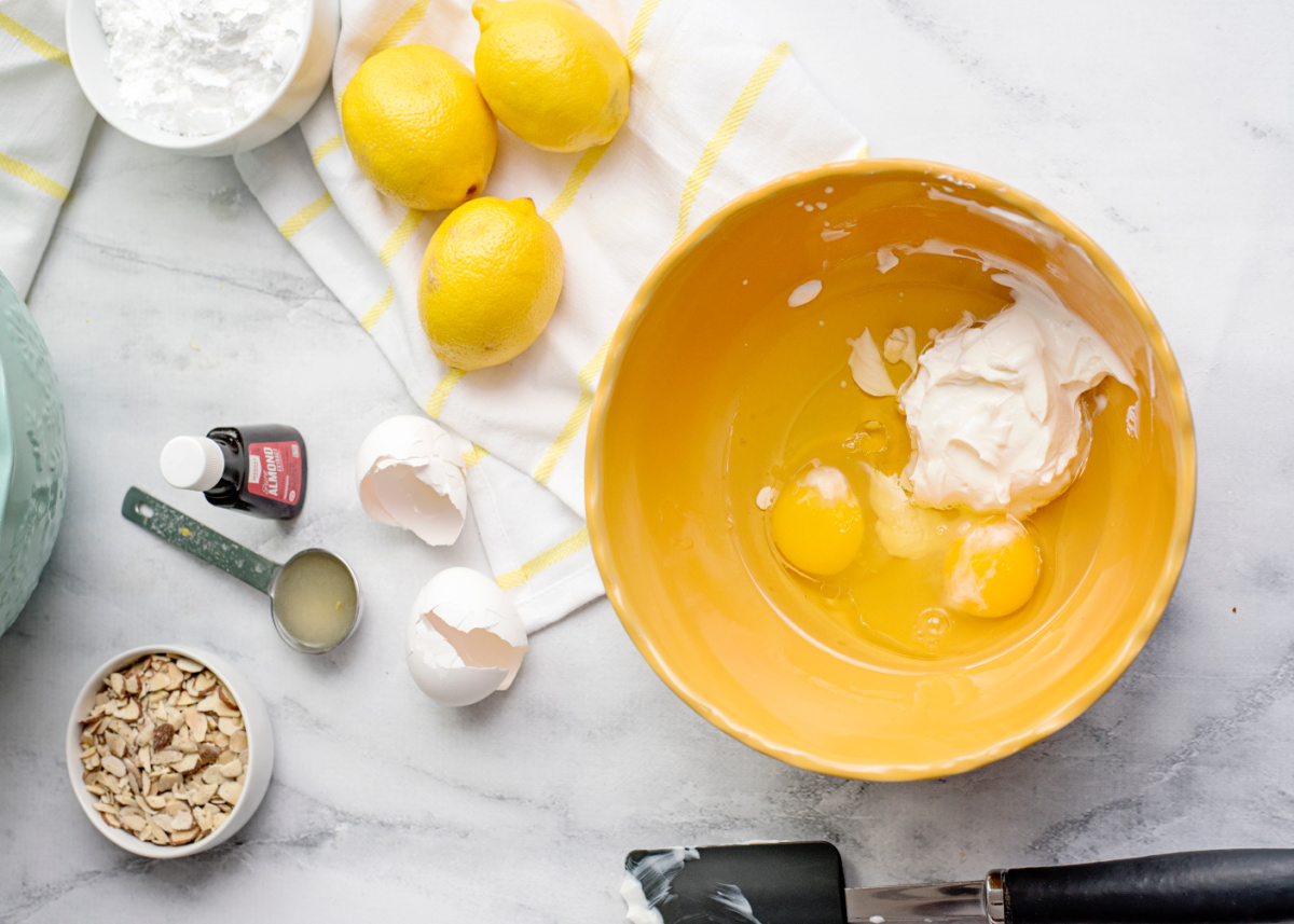 vegetable oil, sour cream, eggs, lemon juice, and almond extract in a bowl
