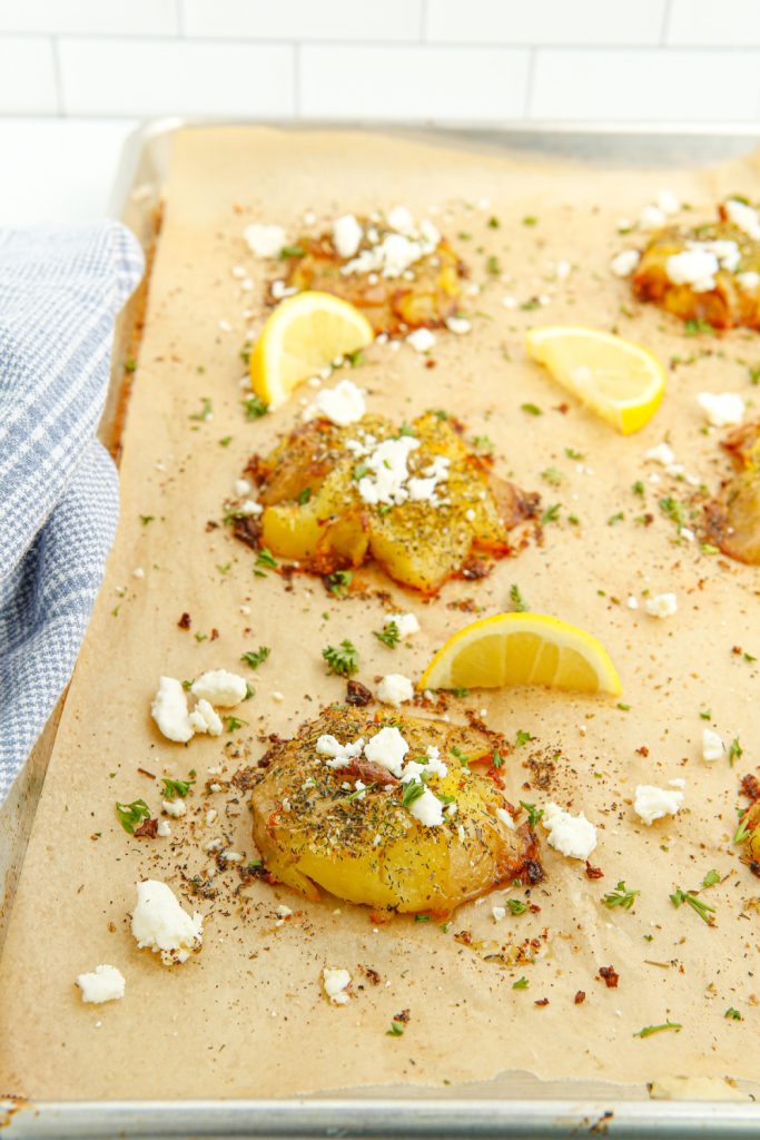 Crispy Greek Smashed Potatoes on a baking sheet