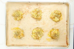 smashed potatoes on a baking sheet