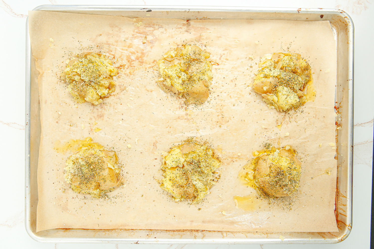 smashed potatoes on a baking sheet