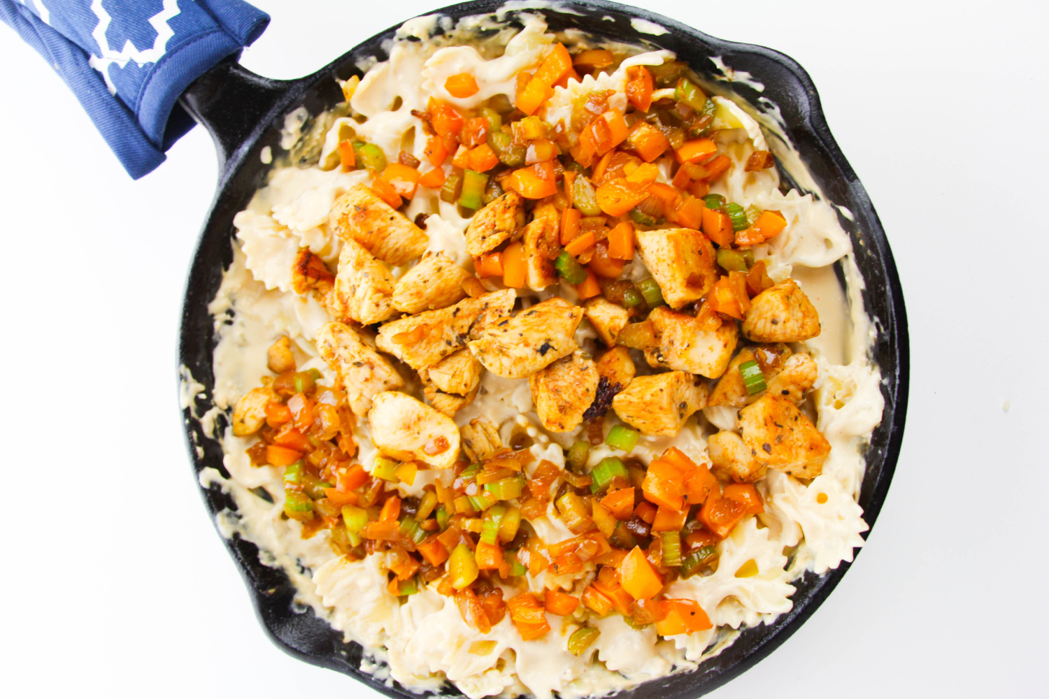 cooked chicken and veggies added to pan with pasta