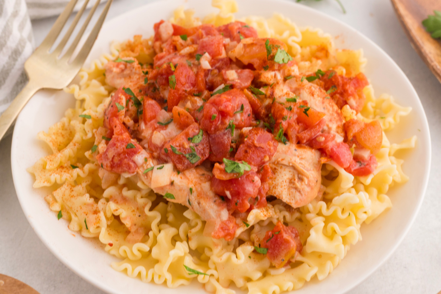 Slow Cooker Chicken Paprikas served over noodles on a plate