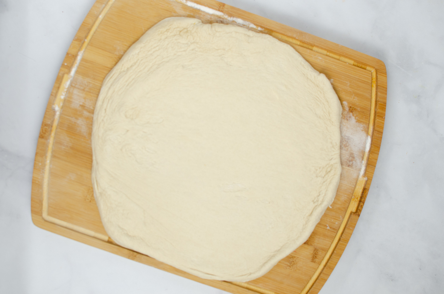 dough rolled out on a cutting board