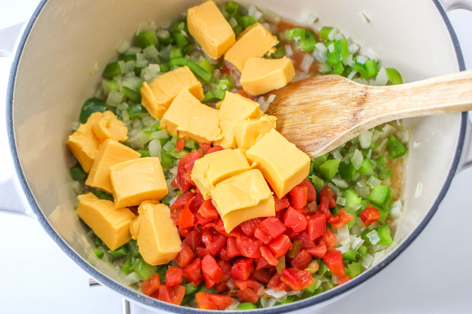 diced tomatoes with green chiles and the cubed Velveeta cheese added to the pan