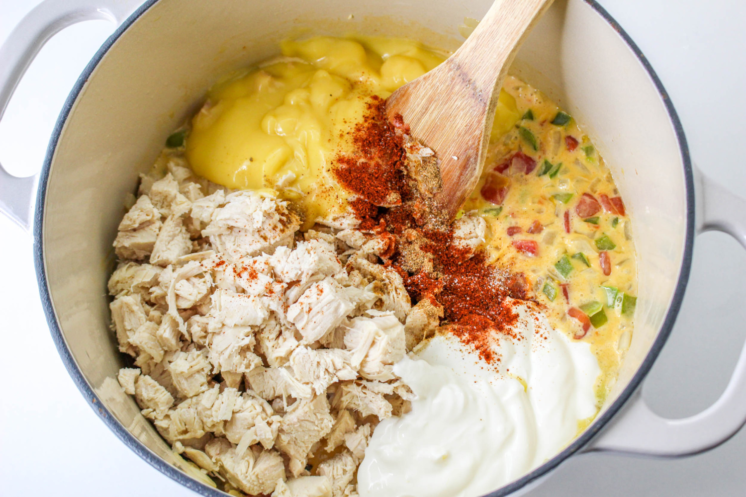 cream of chicken soup, sour cream, cooked chicken, chili powder, and cumin added to pan